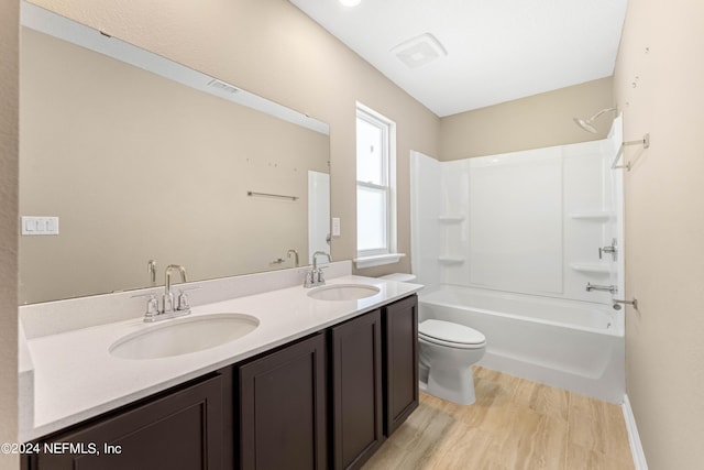 7716 Merchants Way, Jacksonville, FL 32222 - bathroom featuring toilet, a sink, tub / shower combination, and wood finished floors