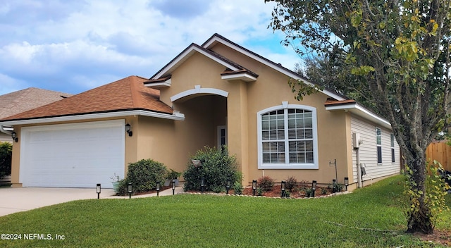 view of front of home featuring a front yard and a garage