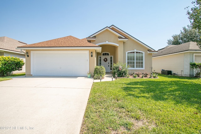 ranch-style house featuring a front yard and a garage