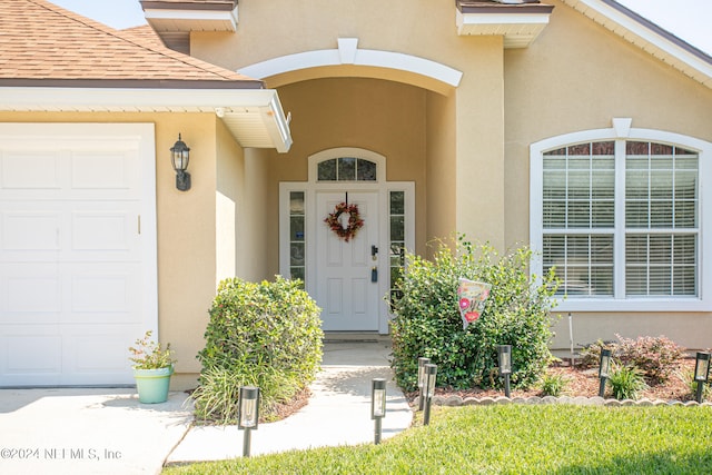 doorway to property featuring a garage