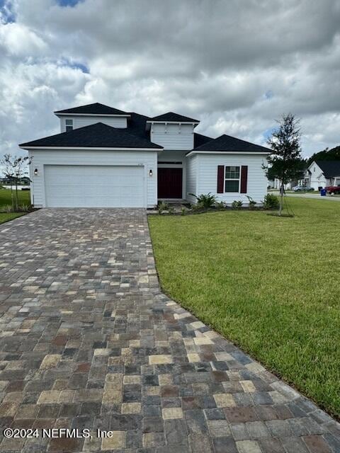 view of front of property with a garage and a front yard