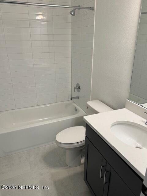 full bathroom featuring tiled shower / bath, vanity, and toilet