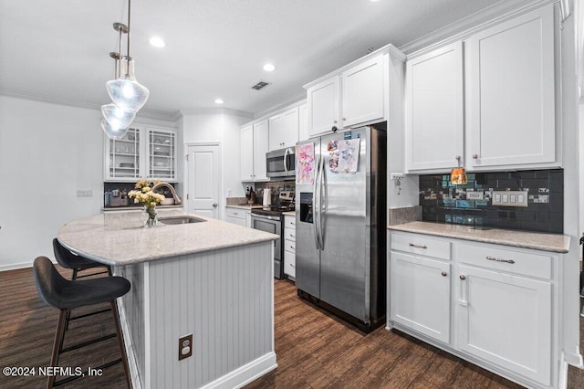 kitchen with stainless steel appliances, sink, a center island with sink, white cabinets, and dark hardwood / wood-style floors