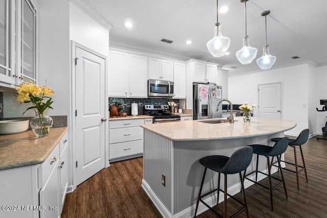 kitchen featuring white cabinetry, sink, hanging light fixtures, dark hardwood / wood-style flooring, and appliances with stainless steel finishes