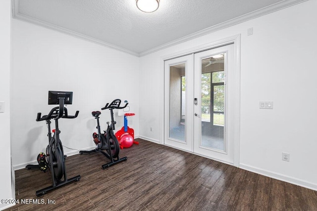 exercise room featuring dark hardwood / wood-style flooring, french doors, a textured ceiling, and ornamental molding