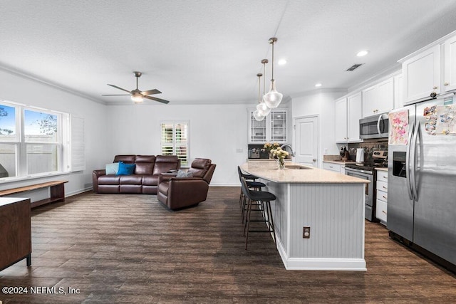 kitchen with a healthy amount of sunlight, sink, white cabinetry, and stainless steel appliances