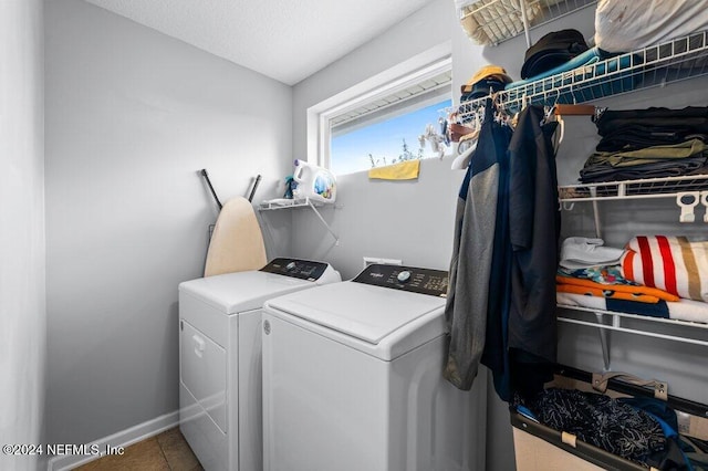 washroom with tile patterned floors, separate washer and dryer, and a textured ceiling