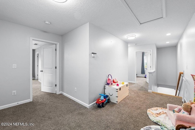 rec room with a textured ceiling and carpet floors