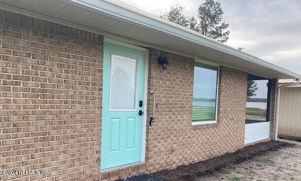 6664 SW 160th St, Starke, FL 32091 - doorway to property with brick siding