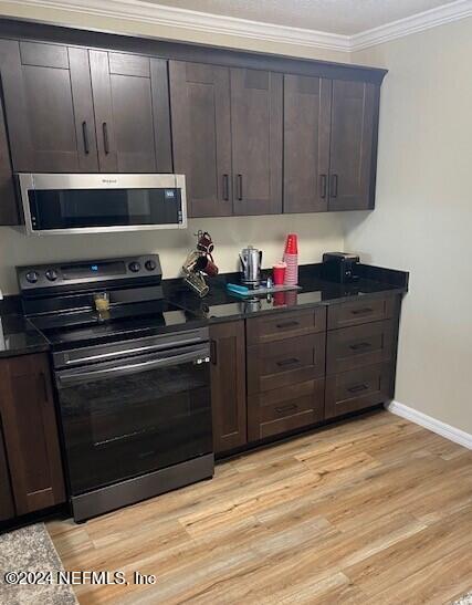 kitchen featuring stainless steel appliances, crown molding, light hardwood / wood-style flooring, and dark brown cabinets