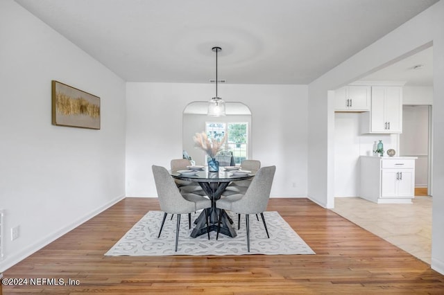 dining space with light hardwood / wood-style floors