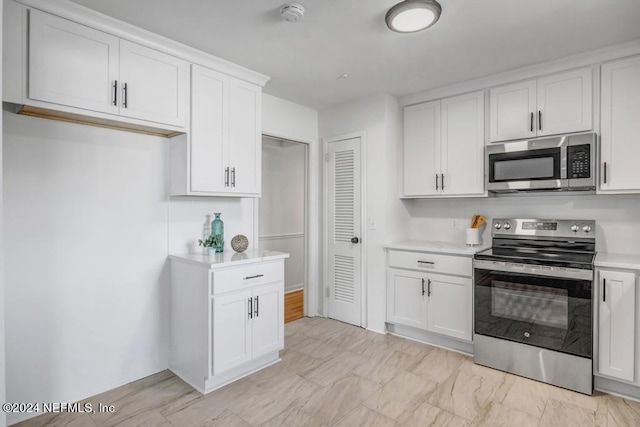 kitchen with appliances with stainless steel finishes and white cabinets