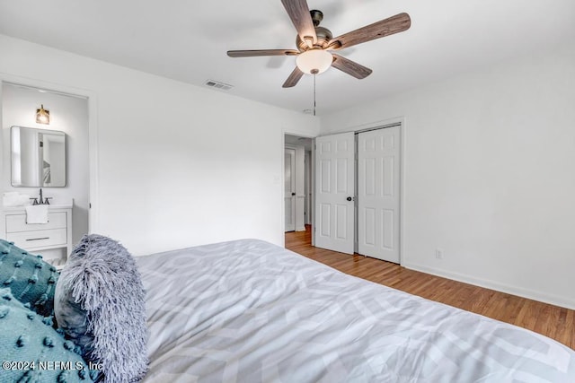 bedroom featuring ceiling fan, a closet, and light hardwood / wood-style flooring