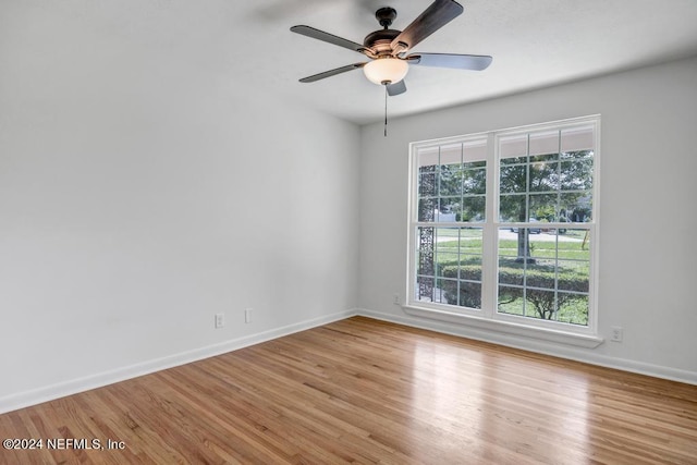 spare room featuring light hardwood / wood-style floors and ceiling fan