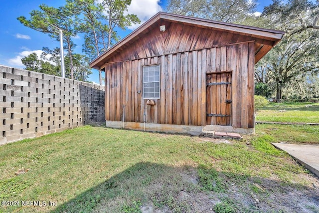 view of outbuilding featuring a yard