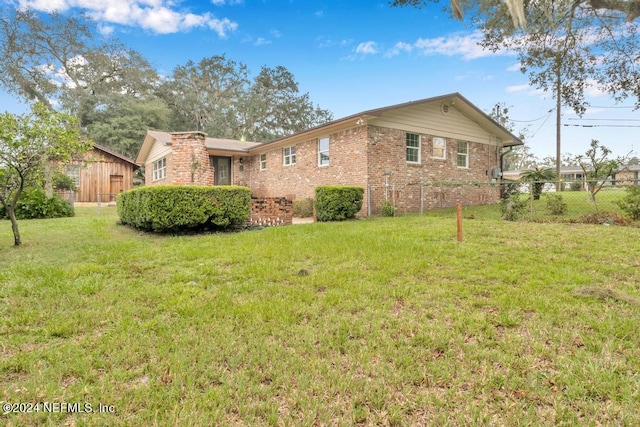 view of side of property with a yard