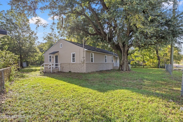 view of home's exterior with a lawn