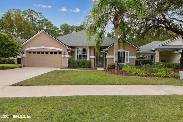 ranch-style home with a front yard and a garage