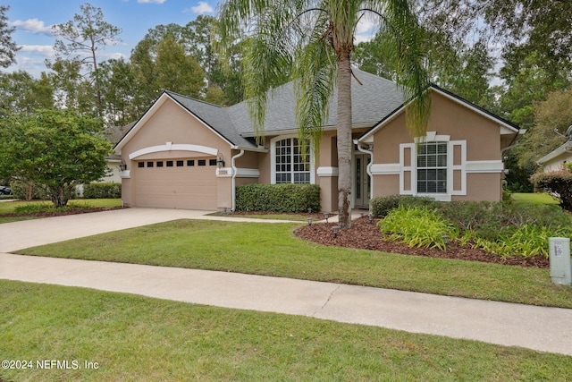 view of front facade with a front yard and a garage