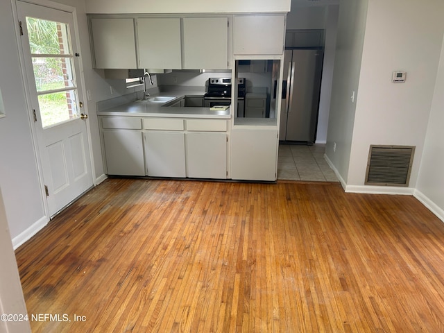 kitchen featuring light hardwood / wood-style floors, appliances with stainless steel finishes, and sink