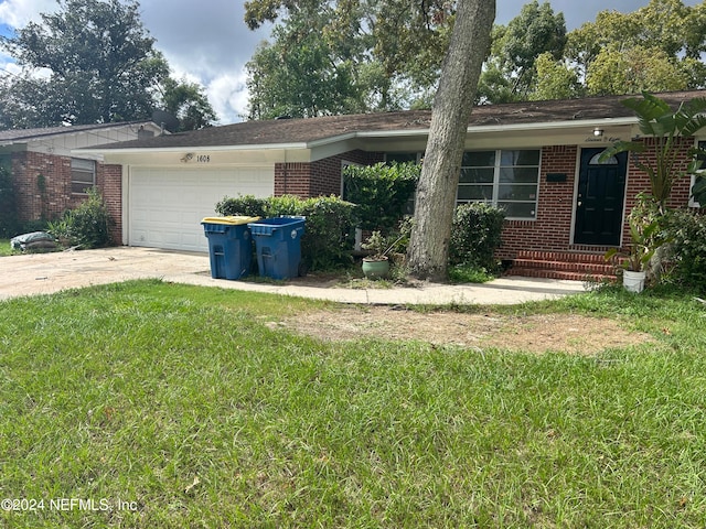 single story home featuring a front yard and a garage