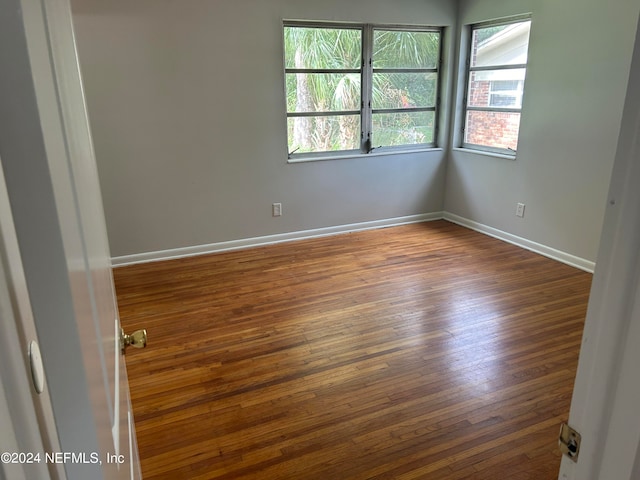 empty room featuring dark hardwood / wood-style flooring