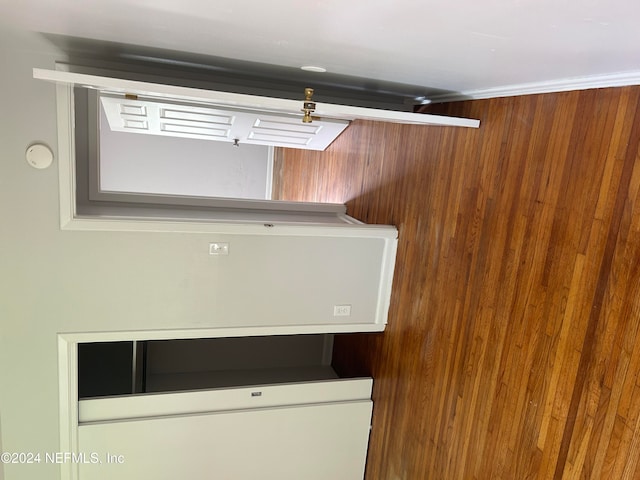 clothes washing area with wood walls