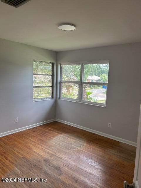 unfurnished room featuring hardwood / wood-style floors