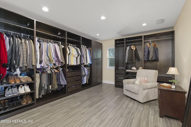 walk in closet featuring light hardwood / wood-style flooring