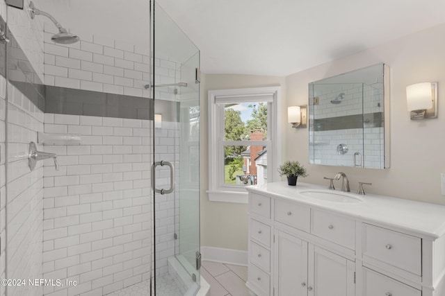 bathroom with vanity, a shower with shower door, and tile patterned flooring