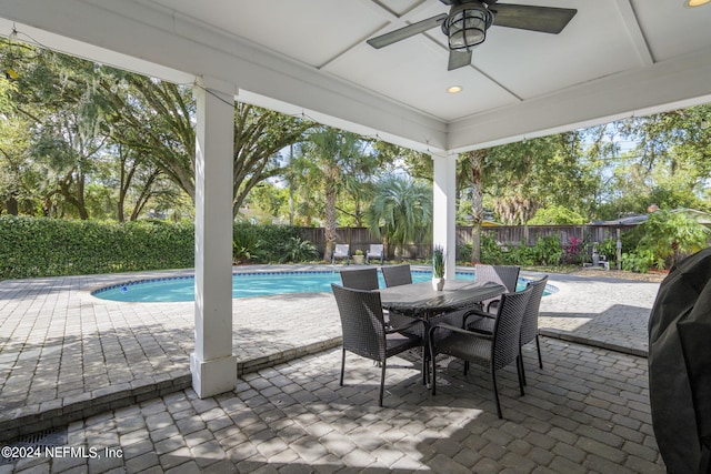 view of patio / terrace featuring a fenced in pool and ceiling fan