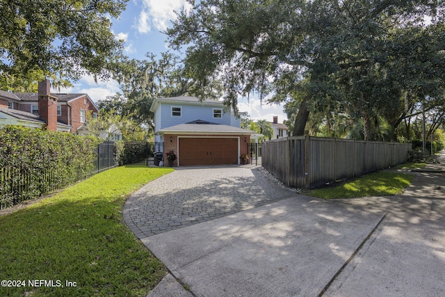 exterior space featuring a front lawn and a garage