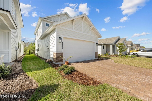 exterior space featuring a lawn and a garage