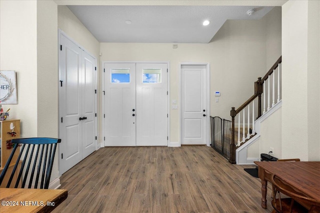 foyer with wood-type flooring and a textured ceiling