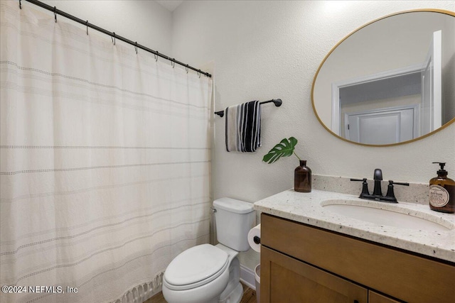 bathroom with a shower with curtain, vanity, and toilet