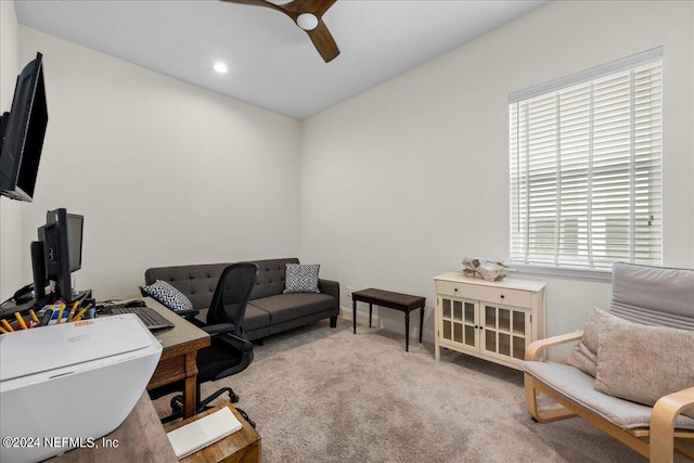 home office featuring ceiling fan and light carpet