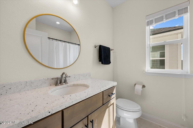 bathroom with vanity, toilet, and tile patterned floors