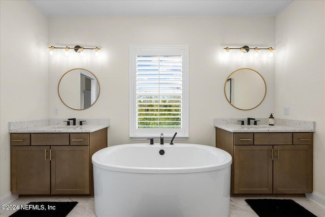 bathroom with vanity, a bath, and tile patterned floors