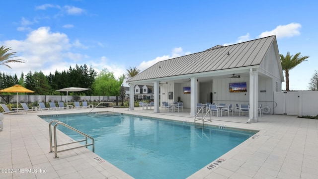 view of pool featuring ceiling fan and a patio area