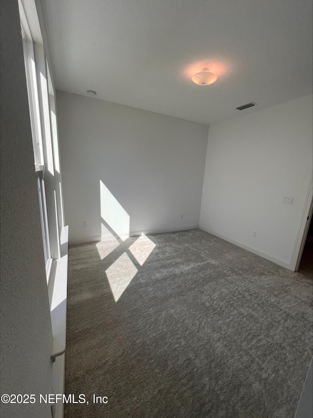 empty room with dark carpet