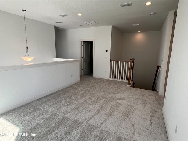 empty room featuring light carpet and a textured ceiling