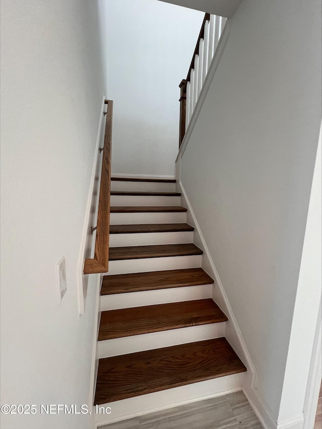 stairs with wood-type flooring