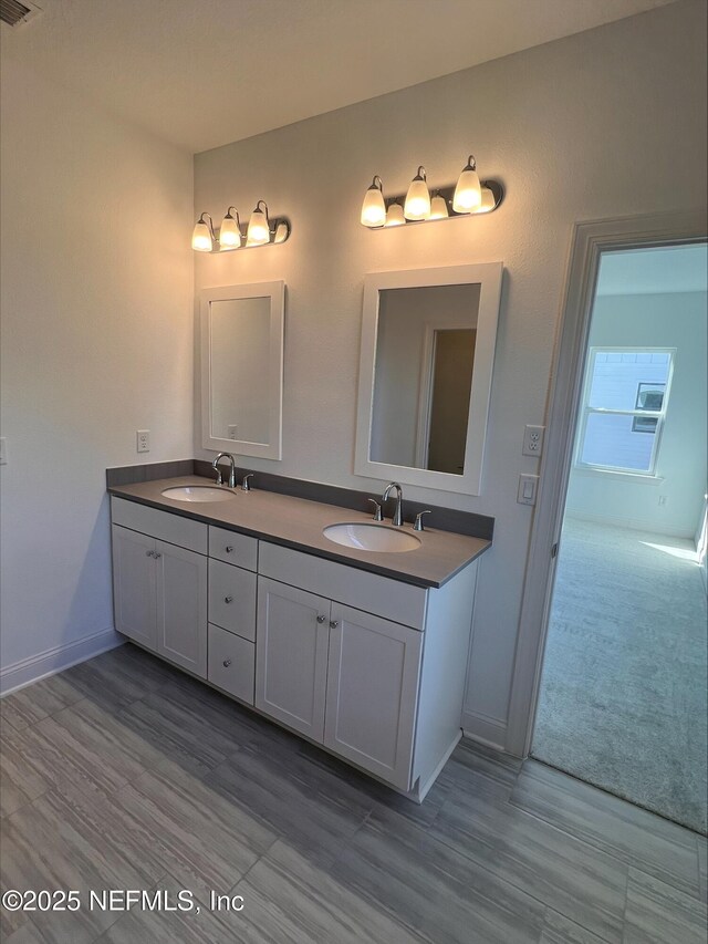 bathroom with vanity and wood-type flooring