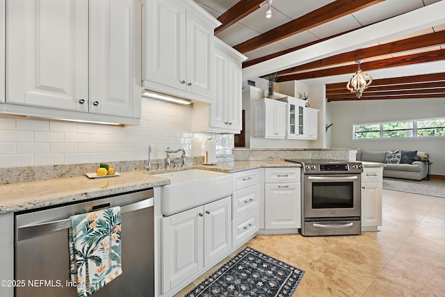 kitchen featuring decorative backsplash, appliances with stainless steel finishes, a sink, white cabinets, and a chandelier