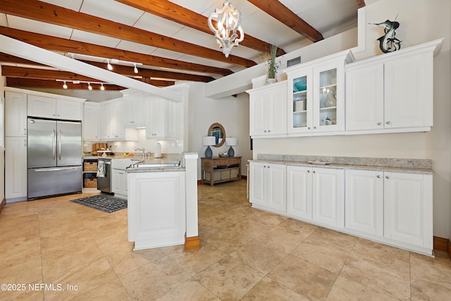 kitchen featuring light countertops, white cabinets, and stainless steel appliances