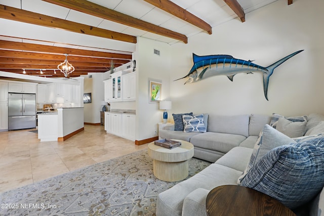 living area featuring visible vents, beam ceiling, light tile patterned flooring, baseboards, and a notable chandelier