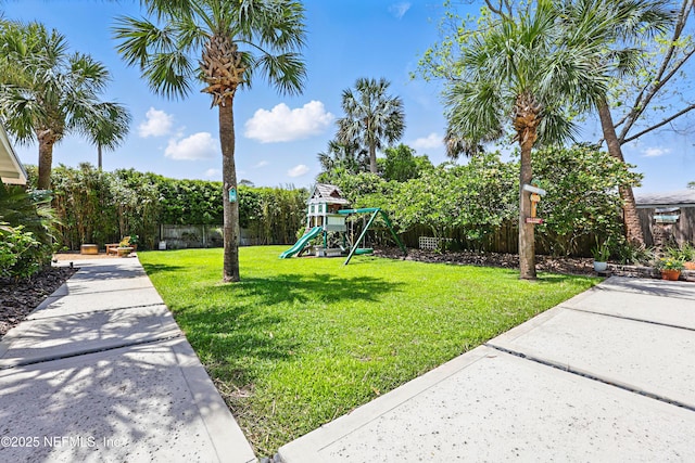 view of yard featuring a playground and a fenced backyard