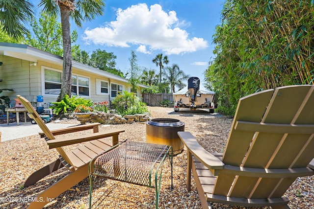 view of patio / terrace featuring fence and a fire pit