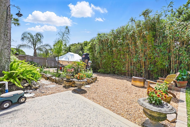 view of yard with a patio area and fence