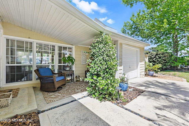 view of patio featuring a garage and driveway